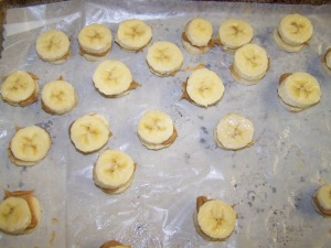 Next is to pull from the freezer and spread a little bit of peanut butter between 2 layers of banana slices. Pop back in the freezer for an hour.