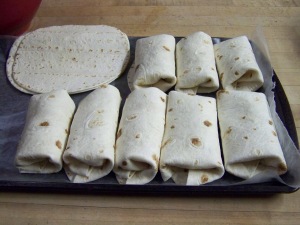 Lay out your tortilla shells and fill, then roll closed. Put on a platter or tray, it goes into the freezer for an hour or so. Transfer into a sealed bag or container to store in the freezer. When needed heat in microwave for 2 minutes and 3 minutes for 2 at a time.